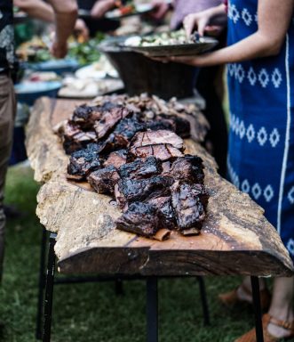 smoked meats on a wooden slab backyard barbecue