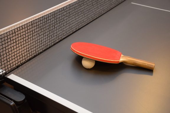 table tennis paddle and ball