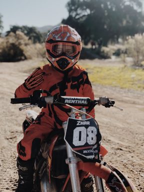 child sitting on dirt bike