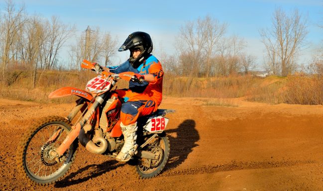 teenager riding motocross dirtbike