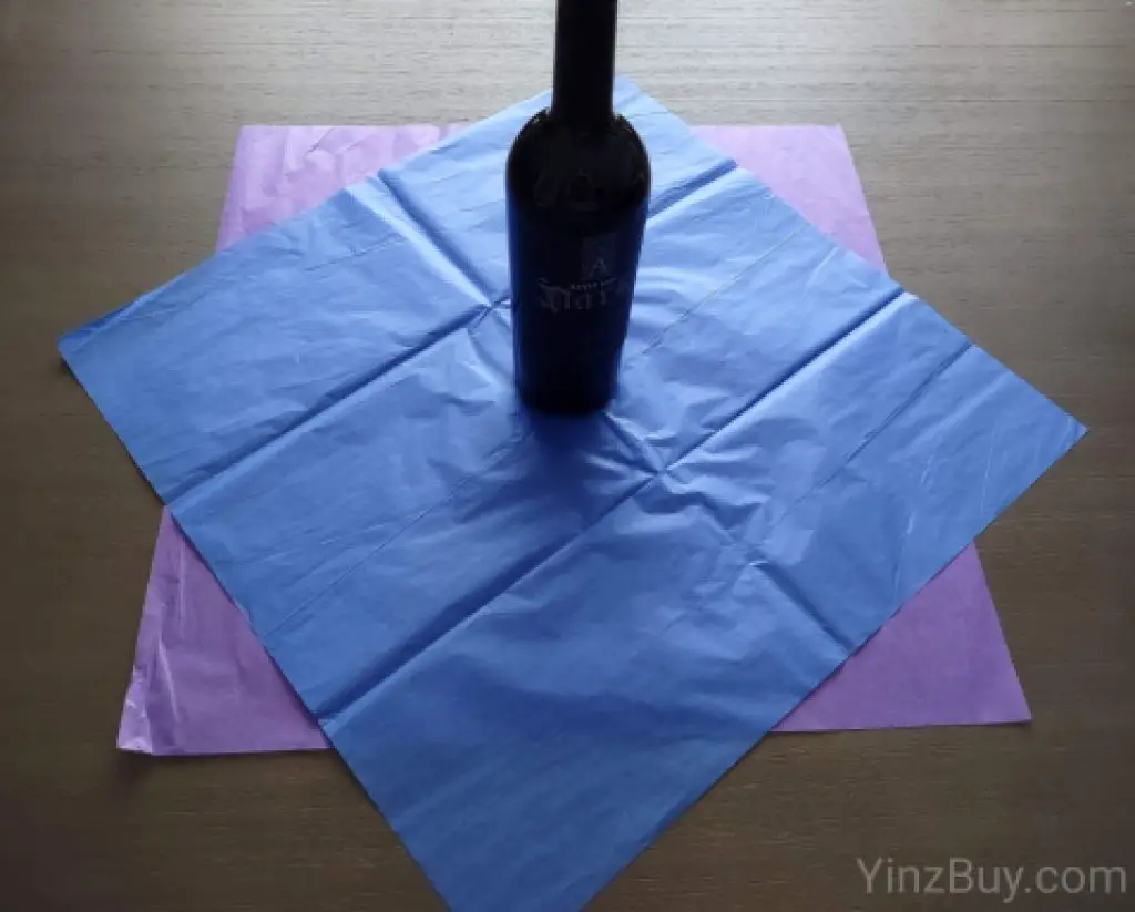 how to put tissue paper in a wine gift bag step 3 place your wine bottle in the center of the tissue paper copyright yinzbuy