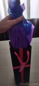 how to put tissue paper in a wine gift bag step 5 place the covered wine bottle in the gift bag copyright yinzbuy