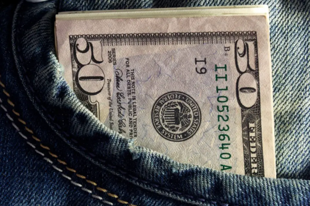 50 dollar bill sticking out of jeans pocket